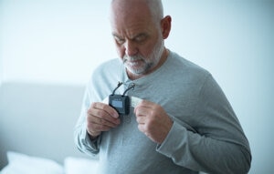 Patient attaching his Resmed diagnostic device