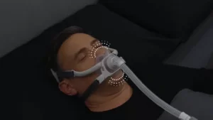 A headshot of a man sleeping peacefully in bed while wearing the AirFit F40 mask.