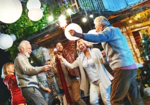 A group of six people of different ages and genders dancing, smiling and enjoying life