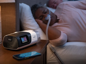 ResMed-sleep-apnoea-patient-sleeping-nasal-mask-CPAP-device-400x300