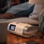 An AirCurve 11 device shown from the front on a bedside table.