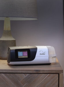 Airsense 11 CPAP device on a nightstand