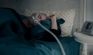 resmed-sleep-apnoea-patient-sleeping-CPAP-mask-device