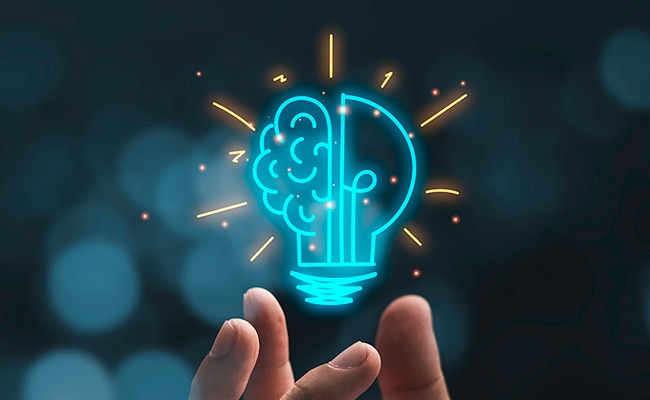 Someone's fingertips holding a cartoon lightbulb, superimposed on the picture, representing scientific innovation.